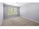 Bright bedroom featuring neutral carpet, large windows, and a ceiling fan at 5471 Rising Tide, North Charleston, SC 29420