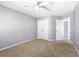 A simply designed bedroom featuring neutral walls, carpet, closet, and attached bath at 5471 Rising Tide, North Charleston, SC 29420
