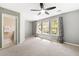 Spacious bedroom with three sunny windows, ceiling fan, and an open bathroom at 5471 Rising Tide, North Charleston, SC 29420