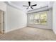 Spacious bedroom with tray ceilings, neutral carpet, and large windows providing natural light at 5471 Rising Tide, North Charleston, SC 29420