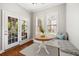 Bright breakfast nook with a round table, cushioned bench seating, and french doors to the outside at 5471 Rising Tide, North Charleston, SC 29420