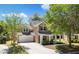 Beautiful two-story home featuring a covered front porch, attached garage, and a serene setting with mature trees at 5471 Rising Tide, North Charleston, SC 29420