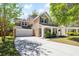 Inviting two-story home featuring a spacious front porch and a well-manicured lawn with mature trees at 5471 Rising Tide, North Charleston, SC 29420
