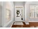 Bright foyer featuring hardwood floors, a stylish front door, and ample natural light at 5471 Rising Tide, North Charleston, SC 29420