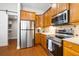 Kitchen featuring stainless steel appliances, wooden cabinets, and granite countertops with a tile backsplash at 5471 Rising Tide, North Charleston, SC 29420