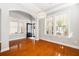 Open-concept living area featuring hardwood floors, large windows, and a stylish light fixture at 5471 Rising Tide, North Charleston, SC 29420