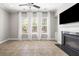 Inviting living room featuring tile flooring, large windows, a ceiling fan, and a cozy fireplace at 5471 Rising Tide, North Charleston, SC 29420