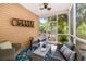 Screened in porch with wicker furniture, a ceiling fan, and a view of the wooded backyard at 5471 Rising Tide, North Charleston, SC 29420