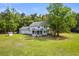 Aerial view of a beautiful home with a spacious yard and lush greenery at 5950 Kelseys Mill Rd, Ravenel, SC 29470