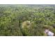 Sprawling aerial shot features a home encircled by a lush forest, alongside a winding stream, showing nature's tranquility at 5950 Kelseys Mill Rd, Ravenel, SC 29470