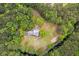 Aerial view of a charming home nestled within a lush green forest landscape, providing privacy and natural beauty at 5950 Kelseys Mill Rd, Ravenel, SC 29470
