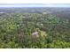 Expansive aerial shot reveals a private residence nestled within a large, densely forested area, hinting at peaceful seclusion at 5950 Kelseys Mill Rd, Ravenel, SC 29470