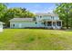 This home features a large backyard with lush green grass and a storage shed at 5950 Kelseys Mill Rd, Ravenel, SC 29470