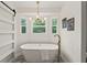 The spacious bathroom features a modern tub with stylish fixtures, a chandelier, and natural light at 5950 Kelseys Mill Rd, Ravenel, SC 29470