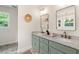 Bathroom features a double sink vanity with modern fixtures and stylish decor and a window view at 5950 Kelseys Mill Rd, Ravenel, SC 29470
