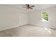 An empty bedroom with a ceiling fan, a closet, a window, neutral walls, and carpeted floors at 5950 Kelseys Mill Rd, Ravenel, SC 29470