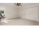 An empty bedroom with a ceiling fan, a closet, neutral walls, and carpeted floors at 5950 Kelseys Mill Rd, Ravenel, SC 29470