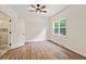 Bright bedroom boasts wood floors, ceiling fan, and an ensuite bath for a luxurious feel at 5950 Kelseys Mill Rd, Ravenel, SC 29470