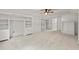 An empty bedroom with a ceiling fan, built-in shelving, neutral walls, and carpeted floors at 5950 Kelseys Mill Rd, Ravenel, SC 29470
