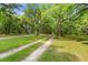 Long, private driveway leading to a beautiful home surrounded by lush greenery at 5950 Kelseys Mill Rd, Ravenel, SC 29470