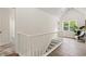 Bright upstairs hallway features natural light, modern railing, and access to bedrooms at 5950 Kelseys Mill Rd, Ravenel, SC 29470
