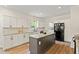 Spacious kitchen with updated appliances, white cabinets and an island at 5950 Kelseys Mill Rd, Ravenel, SC 29470