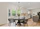 Eat-in kitchen features modern lighting, updated cabinets, and views to the backyard at 5950 Kelseys Mill Rd, Ravenel, SC 29470