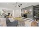 Bright living room with fireplace, ceiling fan, and decorative rug at 5950 Kelseys Mill Rd, Ravenel, SC 29470