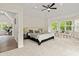 Airy main bedroom boasts natural light, tray ceilings, fan, and calming neutral tones at 5950 Kelseys Mill Rd, Ravenel, SC 29470