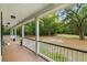 Inviting outdoor patio offers serene views of lush greenery, providing a perfect spot for relaxation at 5950 Kelseys Mill Rd, Ravenel, SC 29470