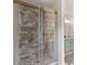 The modern shower features stone tile, glass doors, and access to the shared bathroom at 5950 Kelseys Mill Rd, Ravenel, SC 29470