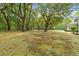 This lush yard features mature trees that provide ample shade and beauty at 5950 Kelseys Mill Rd, Ravenel, SC 29470