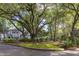 View of the building with well-maintained landscaping and mature trees, providing a serene environment at 60 Fenwick Hall Aly # 937, Johns Island, SC 29455