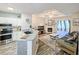 Bright, open-concept living space with a modern kitchen, cozy fireplace, and ample natural light at 60 Fenwick Hall Aly # 937, Johns Island, SC 29455