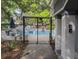 Community Pool with security gate and views of the surrounding homes and mature trees at 60 Fenwick Hall Aly # 937, Johns Island, SC 29455