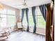 Bright sun room with large windows, a ceiling fan, and wood grain flooring with rocking chairs at 60 Fenwick Hall Aly # 937, Johns Island, SC 29455