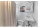 Quaint bathroom with vanity, toilet, and shower featuring unique artwork at 9 Kracke St # A & B, Charleston, SC 29403