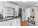 Kitchen showcasing white cabinetry, stainless steel appliances, and a doorway to another room at 9 Kracke St # A & B, Charleston, SC 29403
