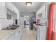 Bright kitchen with white cabinets, stainless steel sink, and gas range at 9 Kracke St # A & B, Charleston, SC 29403