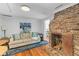 Comfortable living room featuring hardwood floors, a brick fireplace, and a cozy couch at 9 Kracke St # A & B, Charleston, SC 29403