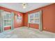 Bedroom features large windows with view, modern art and terra-cotta color walls at 9609 Portal Ct, Summerville, SC 29485
