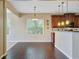 Bright dining area with hardwood floors, a stylish chandelier, and natural light from large windows at 9609 Portal Ct, Summerville, SC 29485