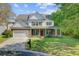 Charming two-story home featuring a brick facade, covered porch, and well-manicured front lawn at 9609 Portal Ct, Summerville, SC 29485