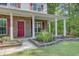 Inviting front porch with brick accents, white columns, and lush landscaping at 9609 Portal Ct, Summerville, SC 29485