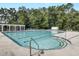 Large swimming pool surrounded by chairs and trees for a relaxing summer experience at 9609 Portal Ct, Summerville, SC 29485