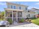 The backyard patio includes a grill, access to the screened porch, lush green grass, and exterior of the home at 9670 Pebble Creek Blvd, Summerville, SC 29485