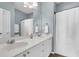 Bright bathroom features dual sinks, a shower curtain, and wood floors at 9670 Pebble Creek Blvd, Summerville, SC 29485