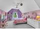 Spacious purple bedroom offers a ceiling fan, large window, shelving and carpet at 9670 Pebble Creek Blvd, Summerville, SC 29485