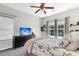 Cozy bedroom features a ceiling fan, dual windows, a large dresser and carpet at 9670 Pebble Creek Blvd, Summerville, SC 29485
