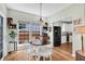 Bright breakfast nook features a wooden table, white chairs and cabinets, and backyard views at 9670 Pebble Creek Blvd, Summerville, SC 29485